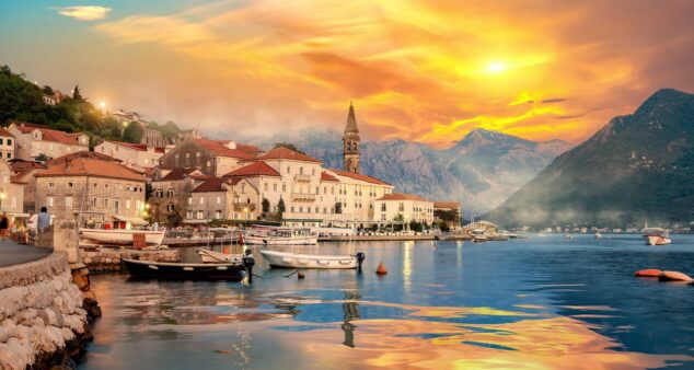 Panoramic view of a picturesque Balkan bay with vibrant fishing boats, showcasing the region's stunning natural beauty. Perfect for your next Grand Voyages vacation.